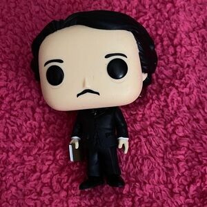 Funko Pop Figure in Black Suit with Book